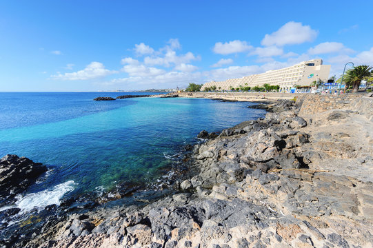 Lagoon with turquoise clear water in Playa Jablillo beach, in Costa Teguise, Lanzarote, Canary islands. Sandy beach with blue sea, volcanic rocks