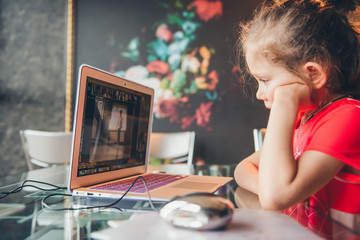 Online remote learning. School kids with computer having video conference chat with teacher and...