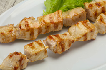 Grilled pork skewer served salad