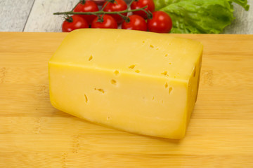 Hard yellow tasty cheese brick