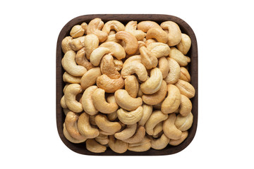 cashew nuts peeled roasted in square bowl isolated on white background. organic food, top view.