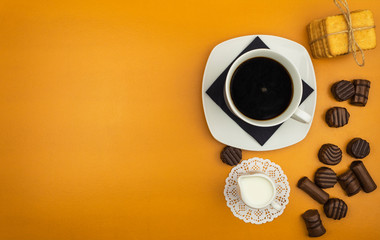 Chocolate candies and coffee with milk