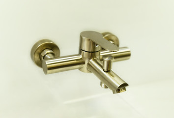 Bronze metal water tap of modern design.Faucet. Selected focus. Bathroom