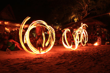 Three strong man juggling fire dancing on the sairee beach koh tao Surat Thani province Thailand 