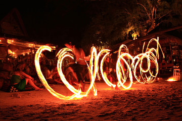 Three strong man juggling fire dancing on the sairee beach koh tao Surat Thani province Thailand 