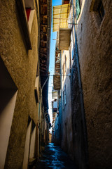 A picturesque shot of a narrow alley in a town in the French Alps on a sunny day in winter (Veynes,...