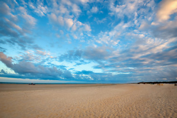 A beautiful sky over a white sandy beach on Pawleys Island, South Carolina.