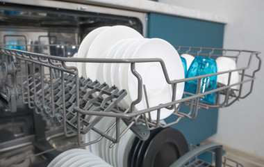 Dishware (plates) inside built-in dishwasher, . Dishwashing machine rack	