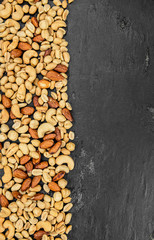 Roasted and salted nuts (close up; selective focus)