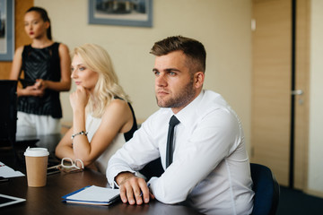 An employee sits during a meeting in the Business, Finance team