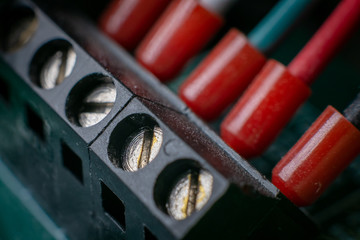 Naklejka premium Close up of screws and red cables