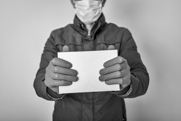 The courier holds cardboard boxes in disposable gloves. Contactless delivery during the quarantine period for coronavirus covid-19 ncov. Stay home and shopping online.