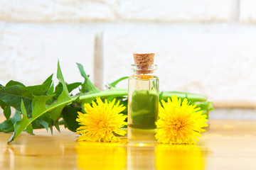 dandelion essential oil in  beautiful bottle on table