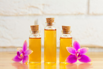 Essence of  orchid flowers on table in beautiful glass jar