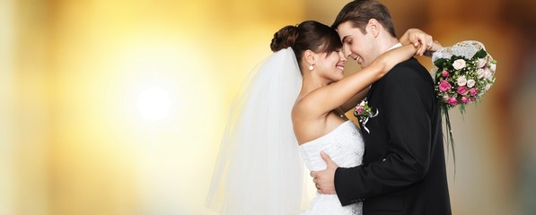 Happy just married young couple on blur background