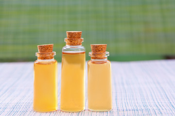 Essence of flowers on table in beautiful glass jar