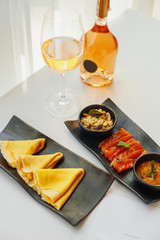 pancakes with red fish, caviar and white wine