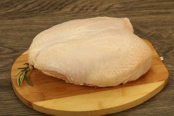 Raw whole chicken breast with skin
