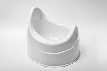 Toilet training chamber pot for small children. Potty pink on a white background.