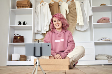 Happy hipster gen z teen girl fashion social media channel blogger with pink hair wear hoodie...