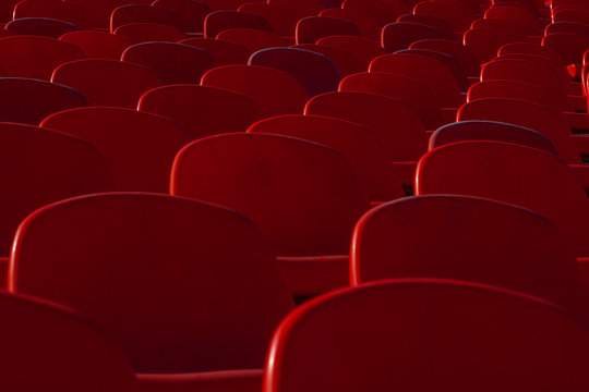 The Backs Of Plastic Seats In A Sports Stadium Are Staggered