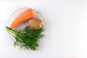 Vegetables; ingredients; fresh; boiled; greens;carrots; top view; close-up; place for inscription.
