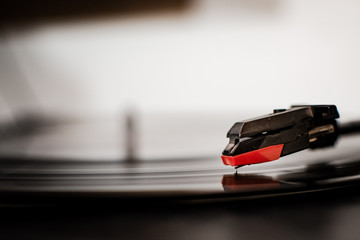 turntable with vinyl turning, detailed photograph of the turntable needle