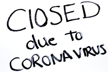 Closed due to Coronavirus pandemic handwritten on a white paper