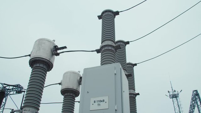 High voltage substation 110 kV with tall pylons and hog voltage distribution cables. Transformation station and electric power close up