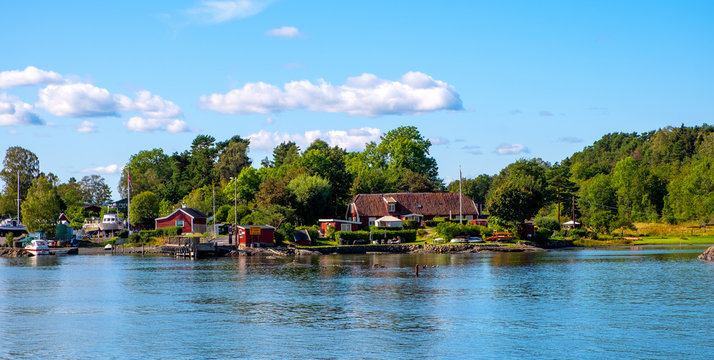 Panoramic view of Lindoya island on Oslofjord harbor near Oslo, Norway, with Lindoya Ost marina and summer cabin houses at shoreline in early autumn