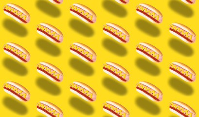 seamless pattern of hot dogs on yellow background