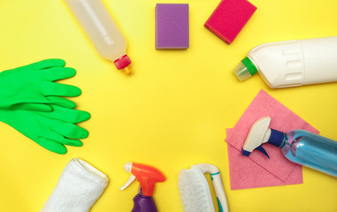 Set of cleaning products on a yellow background, space for text. Disinfection. Flat lay