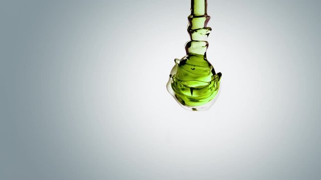 Sustainable green energy and innovation in chemistry. transparent green oil bubbles and fluid shapes floating in zero gravity water on a white gradient background. 