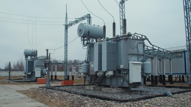 High voltage substation 110 kV with tall pylons and hog voltage distribution cables. Transformation station and electric power 