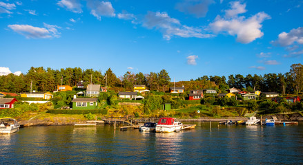 Fototapeta na wymiar Panoramic view of Lindoya island on Oslofjord harbor near Oslo, Norway, with Lindoya Vest marina and summer cabin houses at shoreline in early autumn