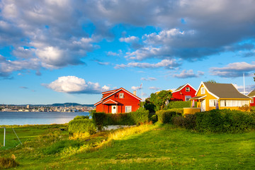Panoramic view of Nakholmen island on Oslofjord harbor with summer cabin houses at shoreline in early autumn near Oslo, Norway - 351028115