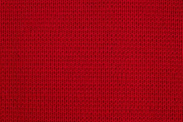 Texture of knitted wool fabric close-up. Red knitted background.The texture of the red wool knitted...