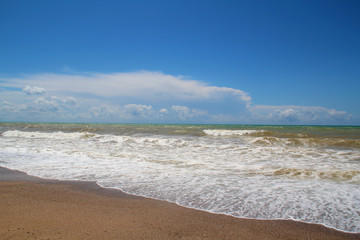 Sea foam in the sand after a big wave and surf