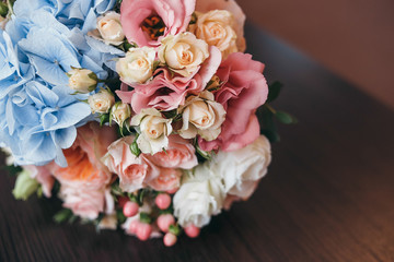 bridal bouquet on a bench. Wedding bouquet consisting of roses with rings