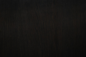 Texture of natural dark brown wood veneer.