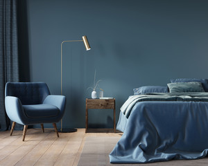 The interior of the bedroom in dark blue with a wide bed, a wooden nightstand and a golden floor lamp