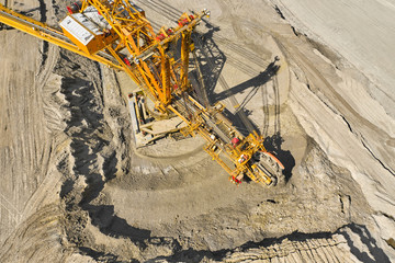 Top view of a bucket wheel excavator mining coal in an open pit mine. 