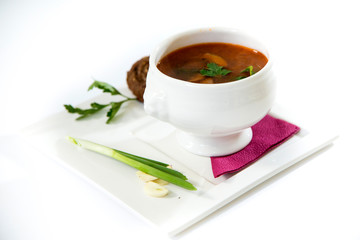 Borscht with pampushka, onion and garlic. Plate on a white background