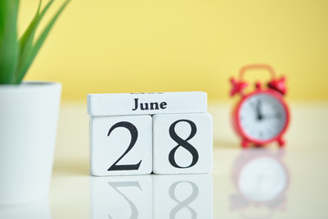 28 twenty eighth day june Month Calendar Concept on Wooden Blocks.
