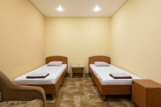 The interior of a budget hotel room with two beds