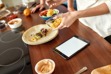 Be healthier. Close up of process of cooking. Woman preparing healthy meal in the kitchen checking recipe using tablet pc. Vegetarianism, healthy food, diet, stay home concept