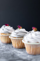 Sweet cupcakes for party. Fresh cupcakes decorated with cream cheese on modern  background. Sweet baked pastry. Holiday cake celebration, delicious dessert, close up