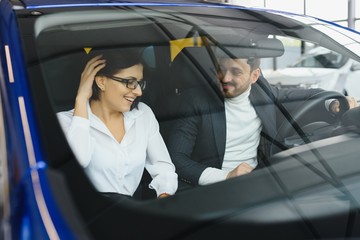 Young business people working together while traveling by a car.