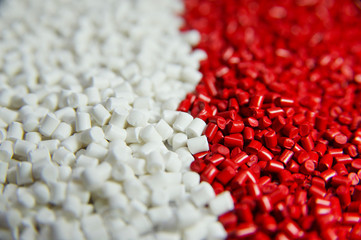 Red and white plastic polymer granules 
