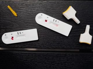 A COUPLE OF SEROLOGICAL TESTS WITH A DROP OF BLOOD ON A BLACK BACKGROUND